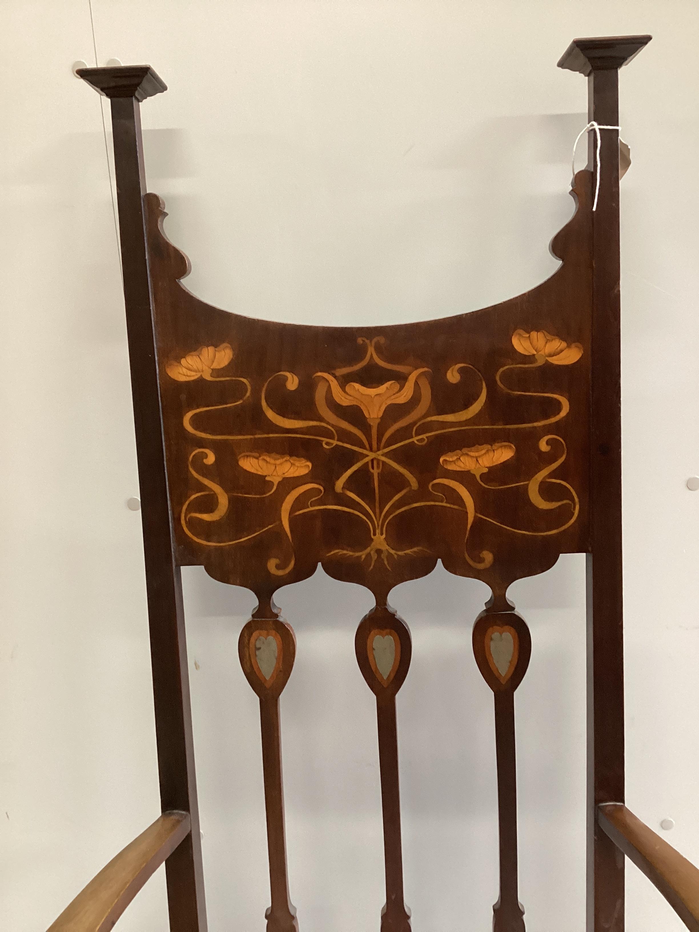 An Art Nouveau inlaid mahogany elbow chair in the manner of Shapland and Petter, width 65cm, depth 48cm, height 131cm